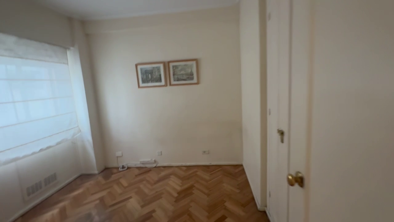 Empty second bedroom or home office with parquet floor