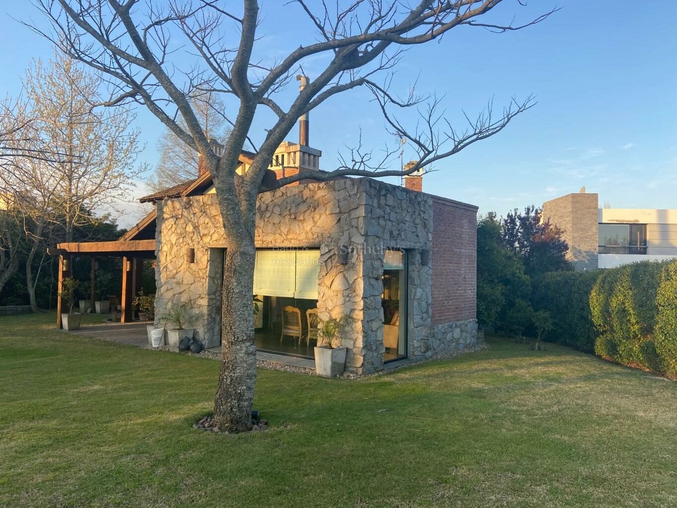 Wide exterior view of the house and its landscaped garden