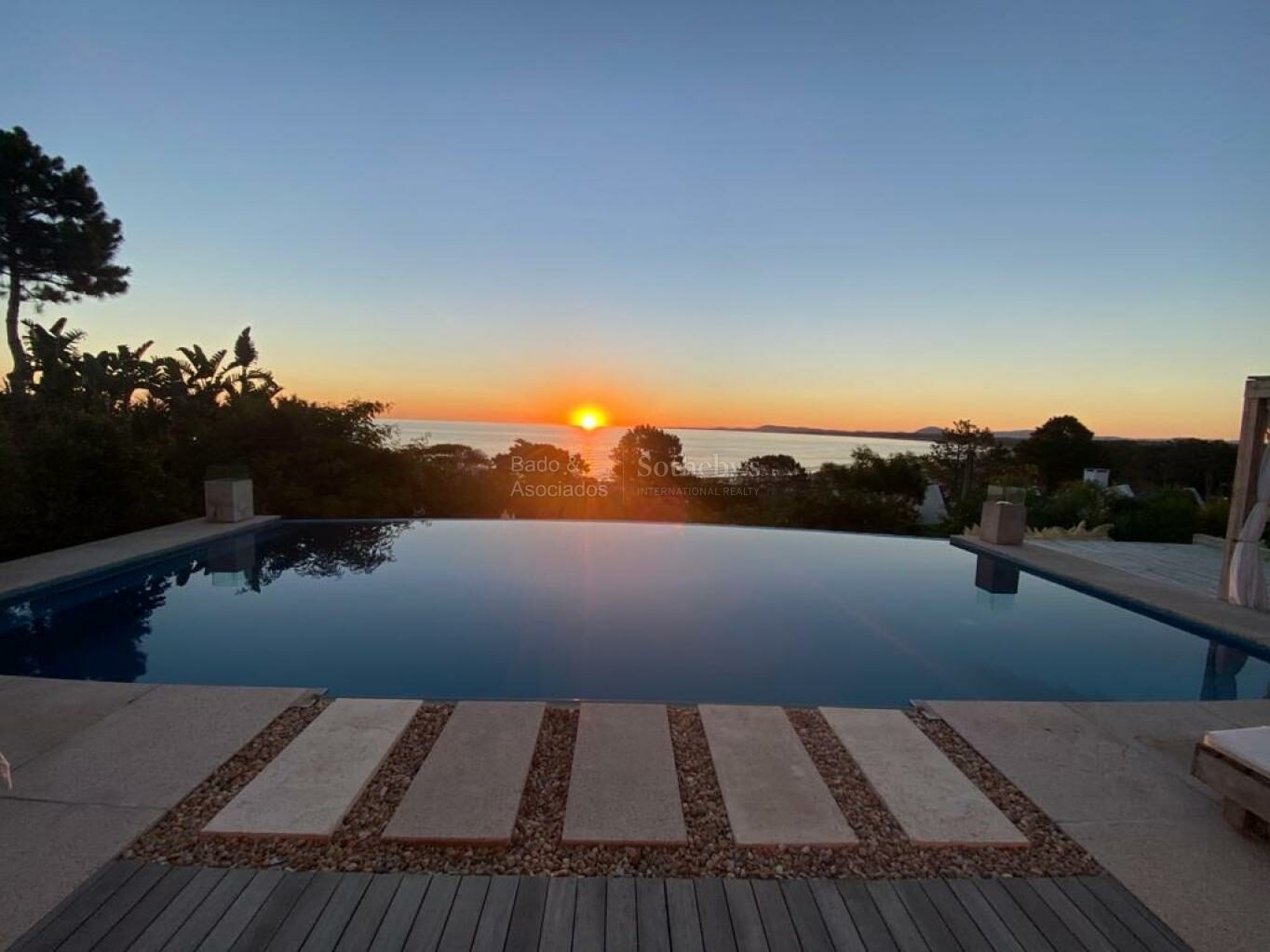Pool terrace at sunset looking out over the water at Punta Ballena