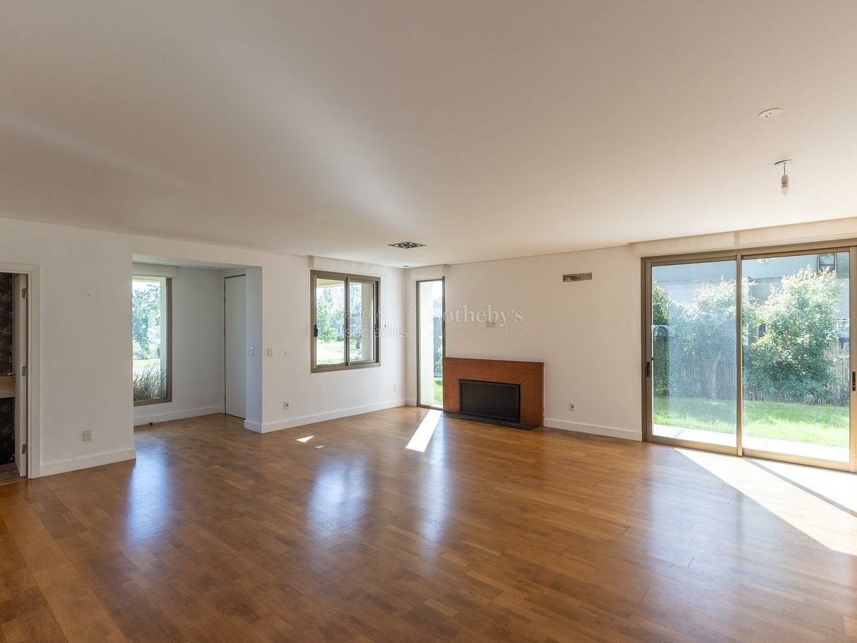 Living room with a fireplace and glazing onto the garden