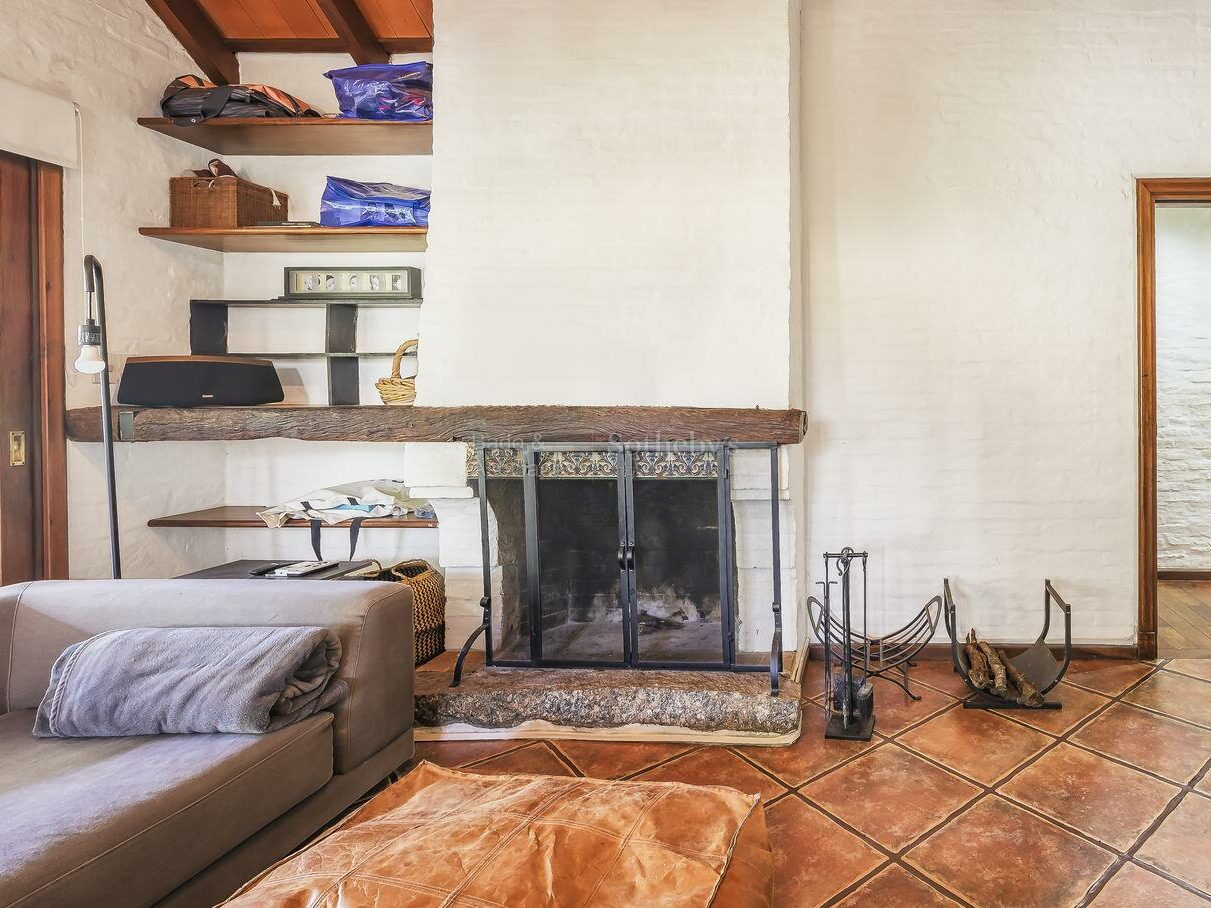 Family room with a fireplace and tiled floor