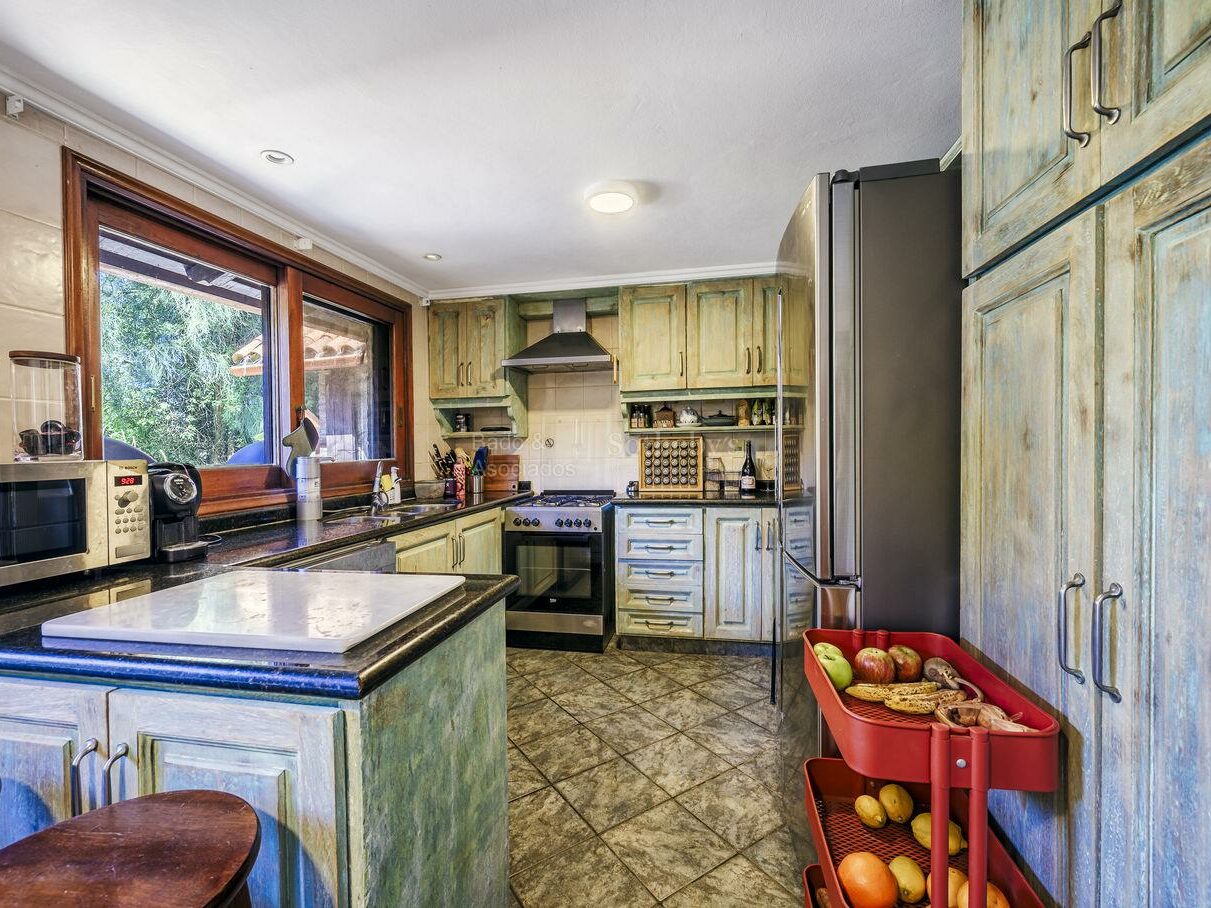 Kitchen with pale cabinetry and a central island