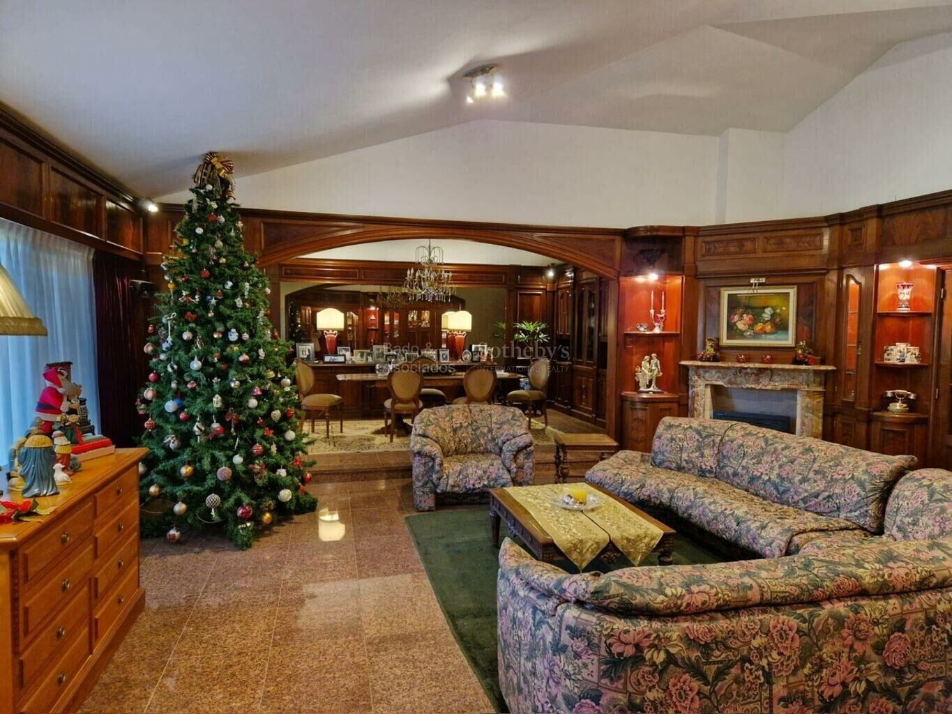 Formal living room with a fireplace and wood paneling
