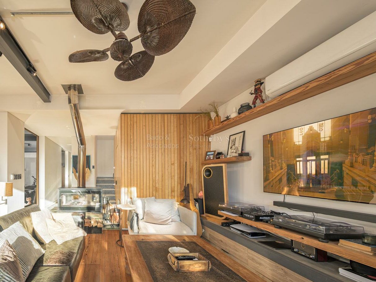 Living room with wood-paneled walls and ceiling