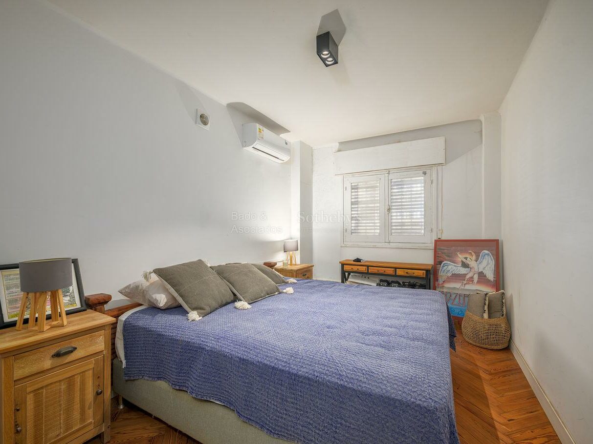 Bedroom with a double bed and shuttered window