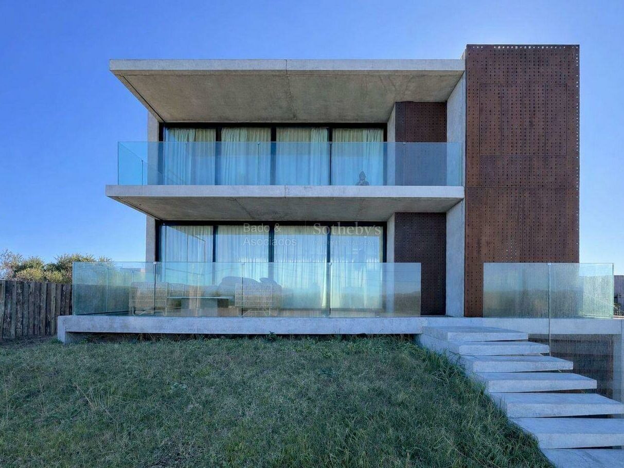 Front elevation of the contemporary house at La Juanita with glazing and timber screens