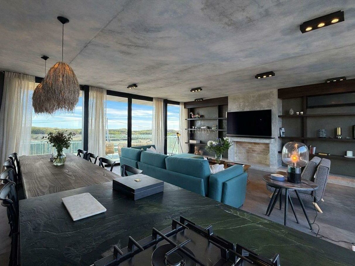 Open-plan living and dining space with sea-facing glazing