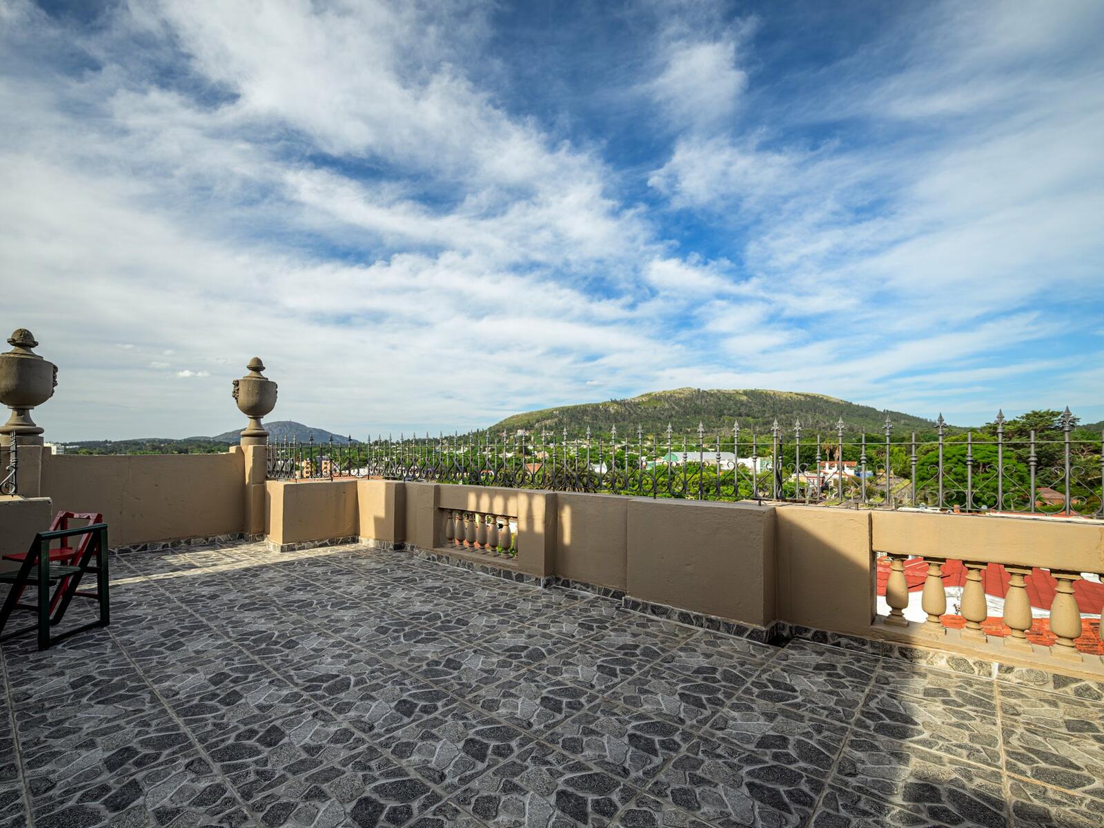 Rooftop terrace of the Piriápolis heritage home looking out over the bay and surrounding hills
