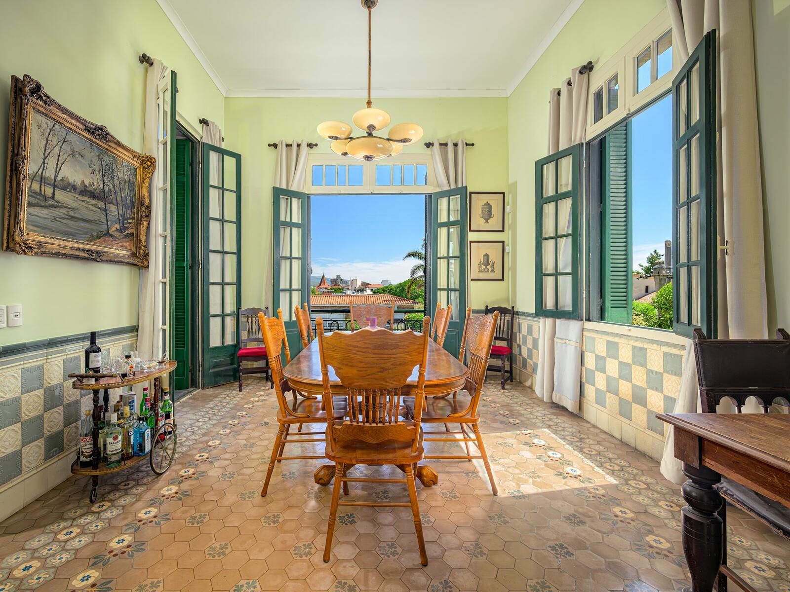 Dining room with original Italian tilework and doors open to the garden