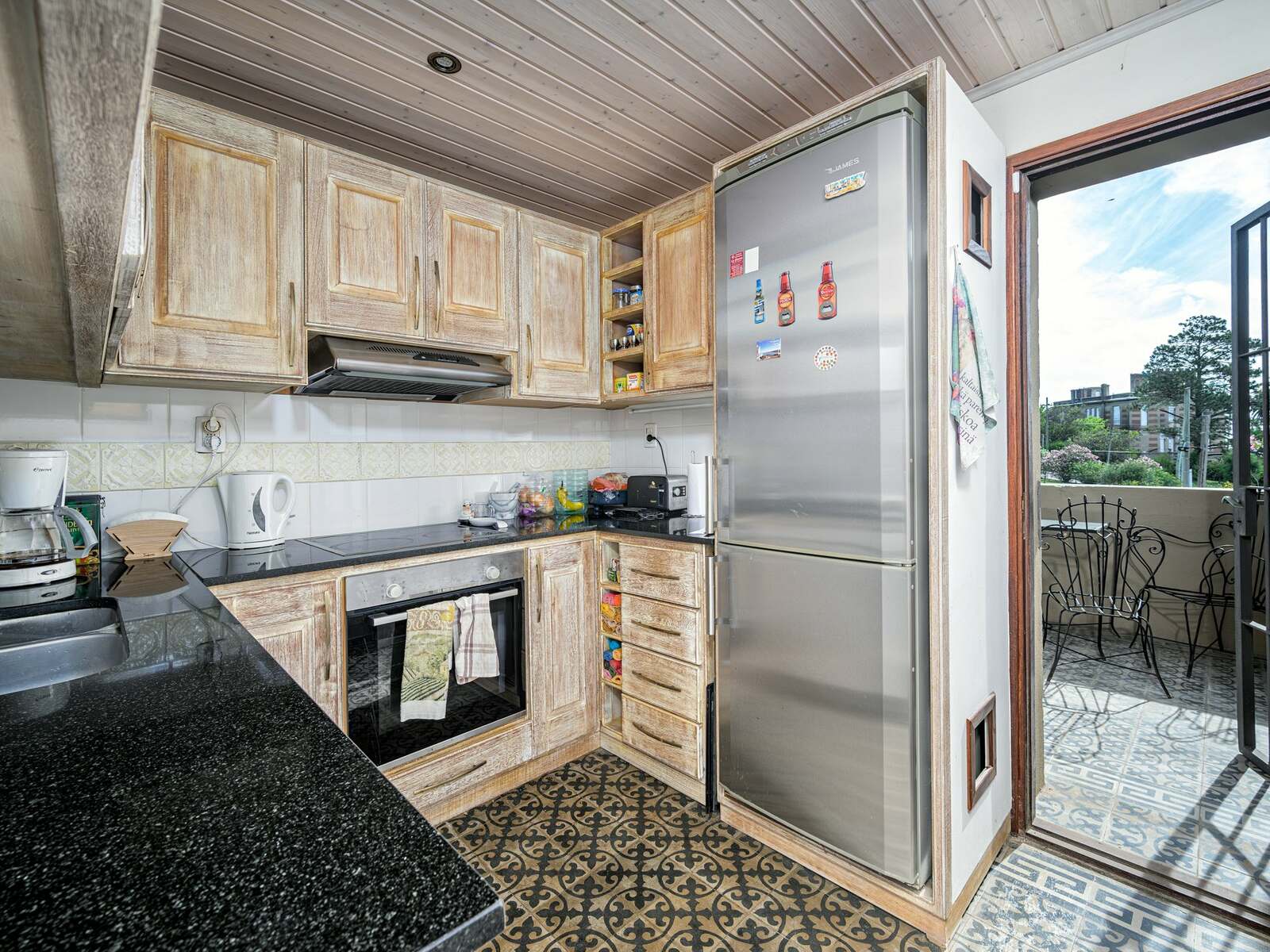 Kitchen with modern appliances and patterned tile floor